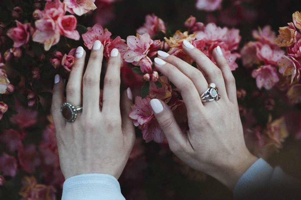 hands touching flowers